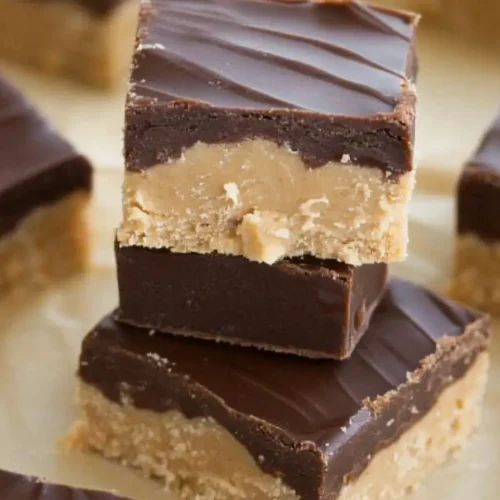 Assorted homemade peanut butter candies on a wooden table