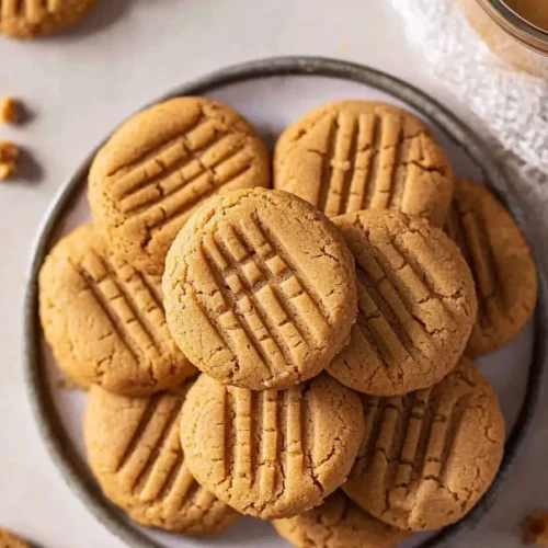 Plate of 3-ingredient peanut butter cookies No Egg with a golden brown texture.